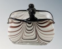 An art glass vase in the form of a basket.