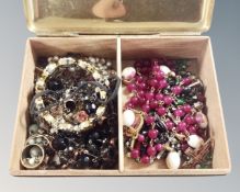 A brass box containing porcelain and glass san Damiano rosary together with a good amount of