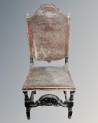 A Victorian carved oak hall chair upholstered in brown tooled leather with brass finials