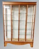 A 20th century four section glazed curio cabinet