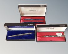 Four boxed Parker pens