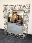 A contemporary wire metal framed mirror decorated with foliage