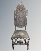 A Victorian carved oak hall chair in tooled studded leather with brass finials