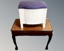 A cutlery table with raised legs and inset leather panel together with loom linen box