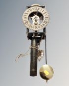 A reproduction wall clock with pendulum and weights