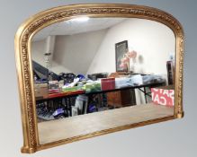 A Victorian style gilt arch topped overmantel mirror,