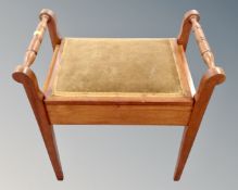 An Edwardian storage piano stool
