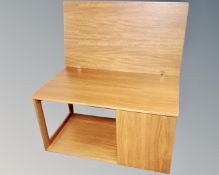 A 20th century teak turn over top coffee table / trolley fitted with cupboard