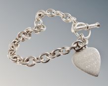 A heavy T-bar bracelet with 'Ghost' heart padlock