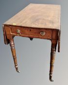 A 19th century mahogany flap sided table fitted a drawer