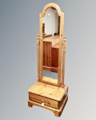 A Ducal pine cheval mirror fitted a drawer