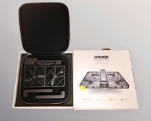 A Hover Camera Passport flying camera drone in box with instructions battery and charger.