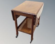 A mid century two tier flap sided tea trolley