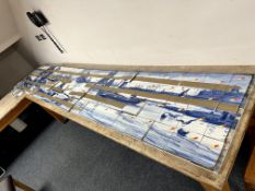 A Minton blue and white glazed tile panoramic seascape,