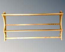 An Ercol elm and beech wall rack