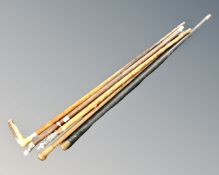 A bundle of seven antique and later walking sticks and canes, including four silver topped examples.