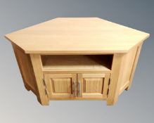 A contemporary oak corner television stand