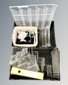 Two crates containing clear perspex display stands together with a metal wall rack,