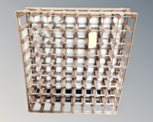 A pine and metal seventy two bottle wine rack