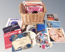 A wicker basket containing a small quantity of vinyl 78's