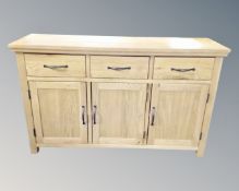 A contemporary oak triple door sideboard