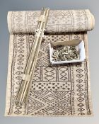 A set of antique brass stair rods with clips together with a carpet runner , length 300 cm x 70 cm,