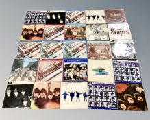 A box containing a quantity of vinyl records including many by The Beatles.