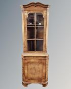 A contemporary burr walnut glazed corner display cabinet with cupboard beneath