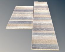 A contemporary striped fringed rug with matching carpet runner CONDITION REPORT: