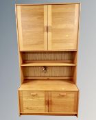 A teak bookcase fitted cupboards and drawers,