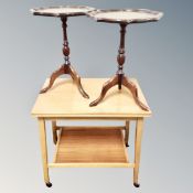 A 20th century teak two tier tea trolley together with a pair of wine tables