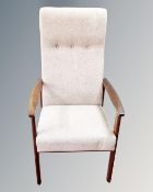 A 20th century stained beech armchair upholstered in an oatmeal fabric.