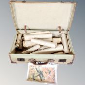 A vintage canvas leather bound trunk containing assorted rolled pictures and prints.