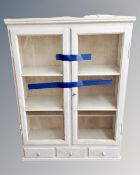 An antique painted pine cabinet fitted with three drawers.