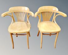 A pair of light beech bentwood chairs.