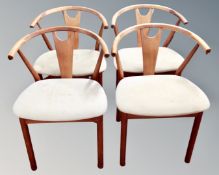 A set of four Scandinavian teak bow backed dining room chairs.