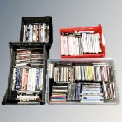 Four crates containing assorted CDs and DVDs.
