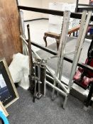 A folding sawhorse stand together with a tile cutter, three sash clamps,