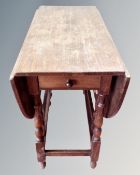 A 20th century oak gateleg table.