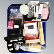 A tray containing Oral-B Pro 600 toothbrush, Icon Bit mobile charger, Zhuzh tan accelerator etc.