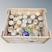 A vintage pine crate containing glass milk bottles