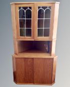 A continental teak corner unit with glazed doors.