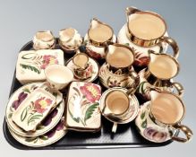 A collection of 20 pieces of Wade hand painted gilded jugs, tea ware, lidded trinket pots etc.