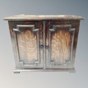 An Edwardian oak counter top double door cabinet fitted with internal shelves.