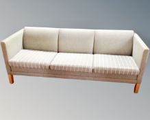 A Scandinavian three seater settee upholstered in a peppermint fabric.