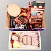 A 20th century painted doll's cot with bedding and a porcelain doll,