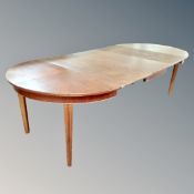 A stained beech extending D-end dining room table with three leaves.