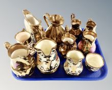A tray containing 10 assorted Wade hand painted lustre jugs together with a further bowl.