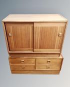 A teak shutter door cabinet together with a low four drawer chest.