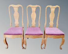 A set of 12 continental oak dining room chairs.